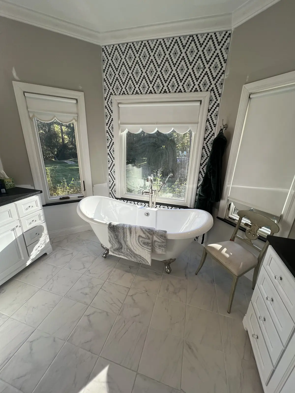 Clawfoot tub against a patterned feature wall